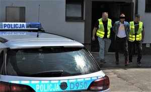 Policjanci doprowadzają zatrzymanego 43-latka