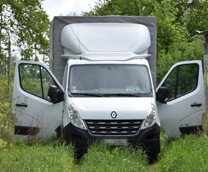 stojący na trawie przy zaroślach samochód marki Renault Master