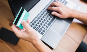 dłoń z kartą płatniczą, w tle laptop