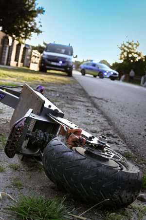 leżąca na drodze hulajnoga, w tle samochody