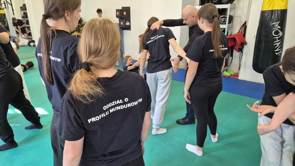 uczennice i policjant na macie