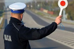 policjant Wydziału Ruchu Drogowego z tarczą do zatrzymania pojazdów